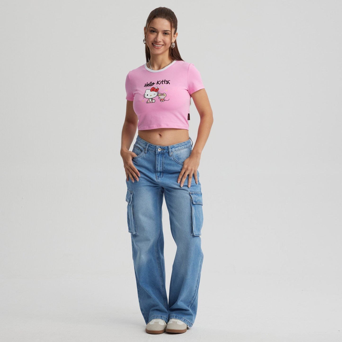 Polera rosada de Hello Kitty con diseño gráfico de la icónica gata y su amiga, en un estilo divertido y moderno, ideal para fans del universo Sanrio.