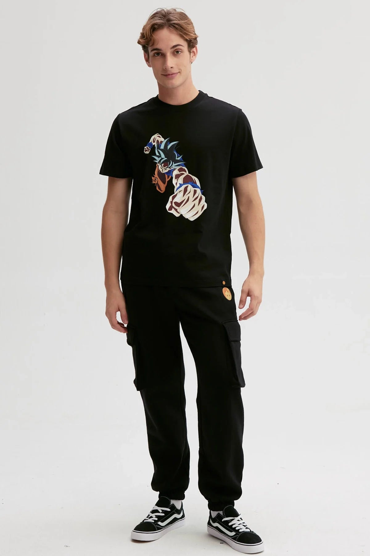 Polera negra de algodón con ilustración de Goku lanzando un puñetazo, estilo anime vibrante y dinámico, captura la esencia de Dragon Ball.