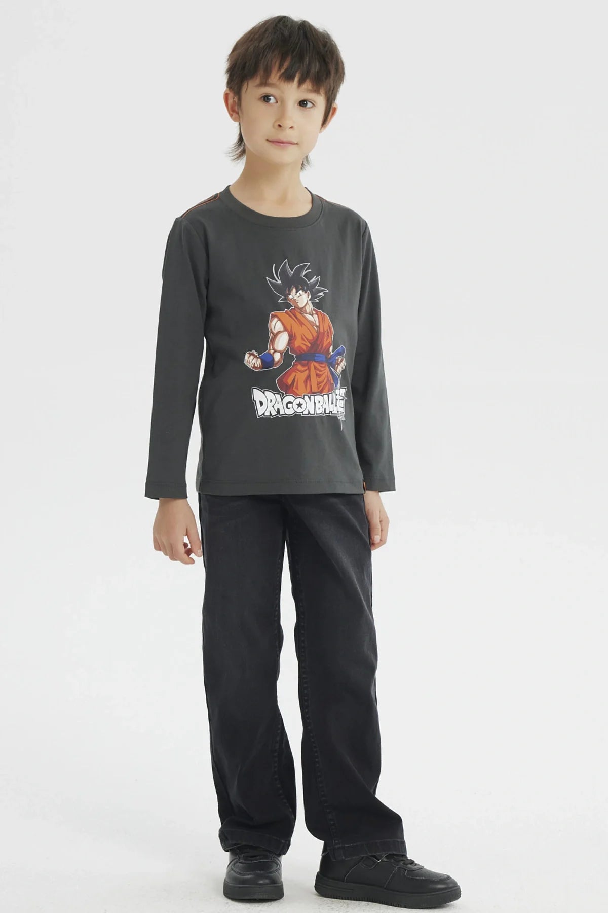Polera gris melange con ilustración de Goku en su traje naranja de Dragon Ball Super, destacando su energía y determinación en un diseño vibrante.