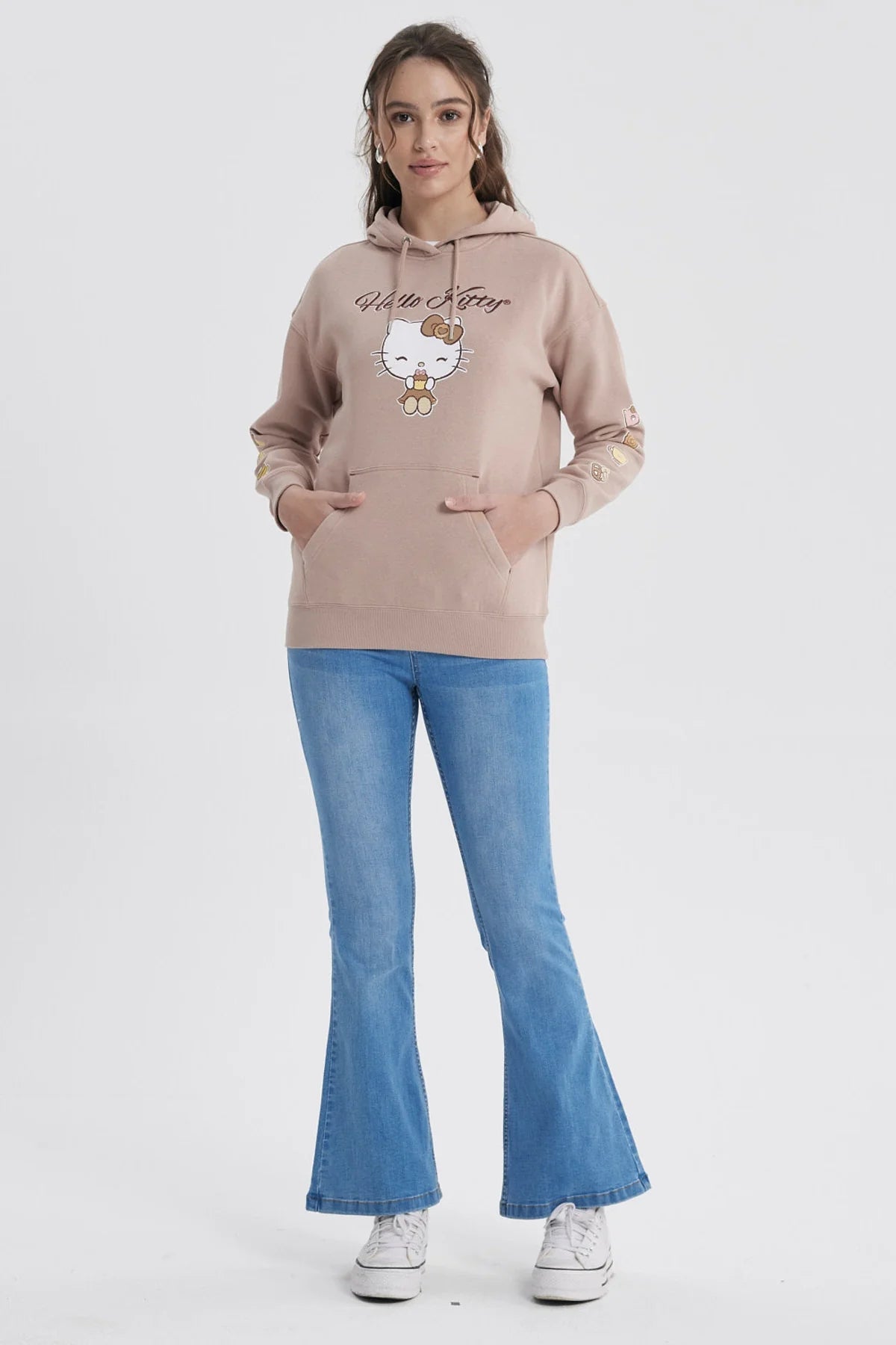 Polerón rosa con capucha de Hello Kitty, presenta un diseño de la icónica gatita sosteniendo un dulce en el centro y pequeños íconos de comida en las mangas.
