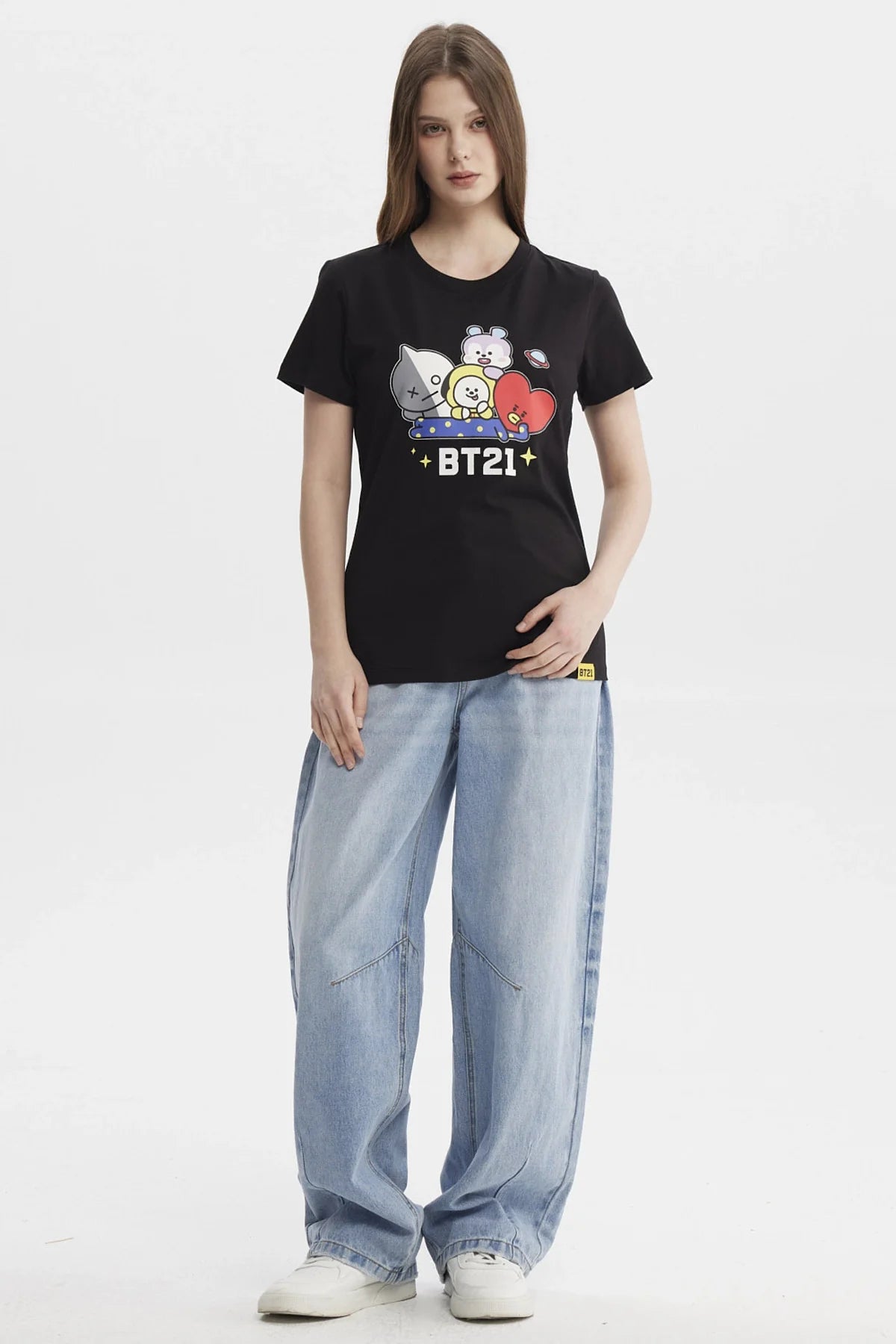 Polera negra con estampado de los personajes de BT21, destacando a Chimmy, Koya, Tata y más en un diseño colorido y divertido, ideal para fans del universo BTS.
