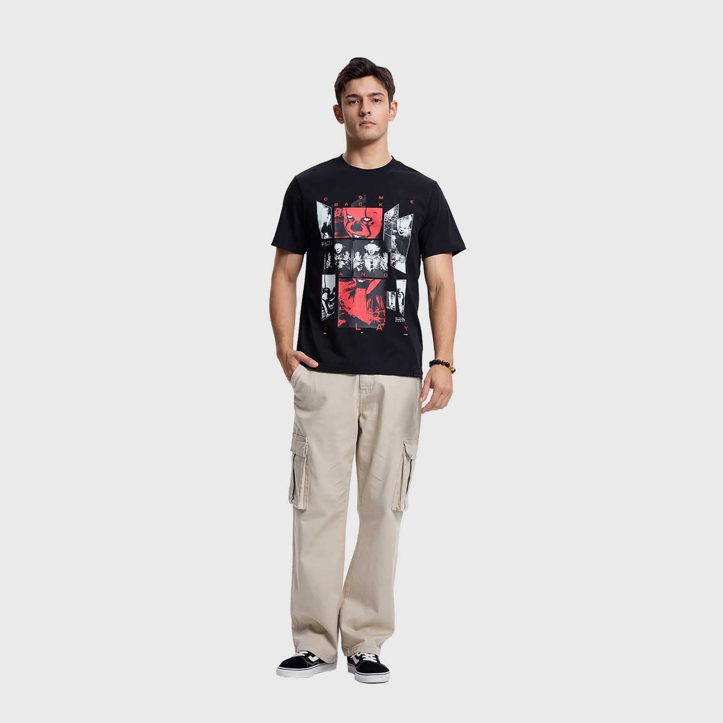 Polera negra de algodón con un diseño gráfico que mezcla imágenes icónicas de la saga "It", resaltando personajes en tonos rojo y blanco, perfecta para fans del horror.
