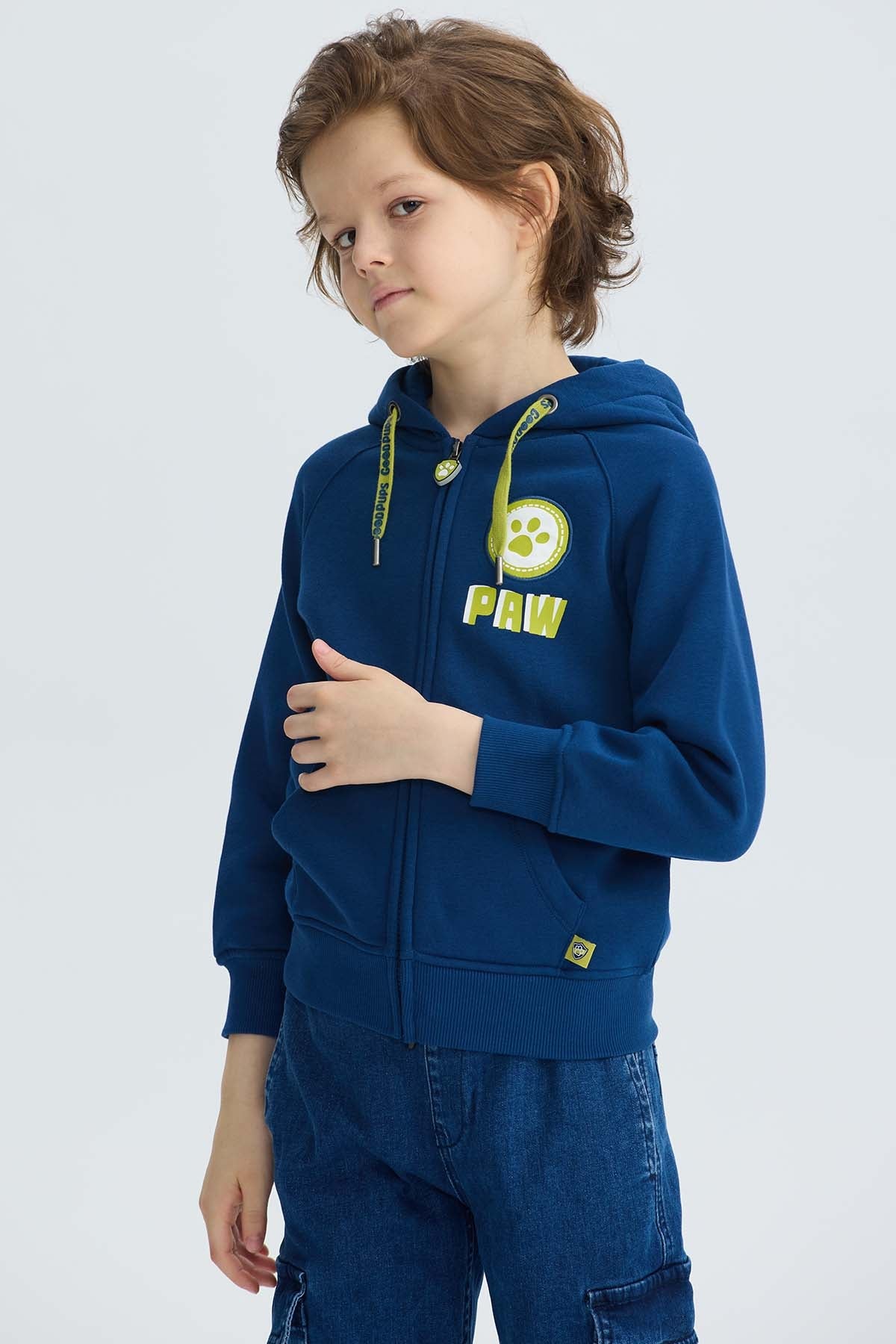 Polerón azul oscuro de Paw Patrol con capucha, presenta un logo circular amarillo y la palabra 'PAW' en un vibrante tono, ideal para pequeños aventureros.