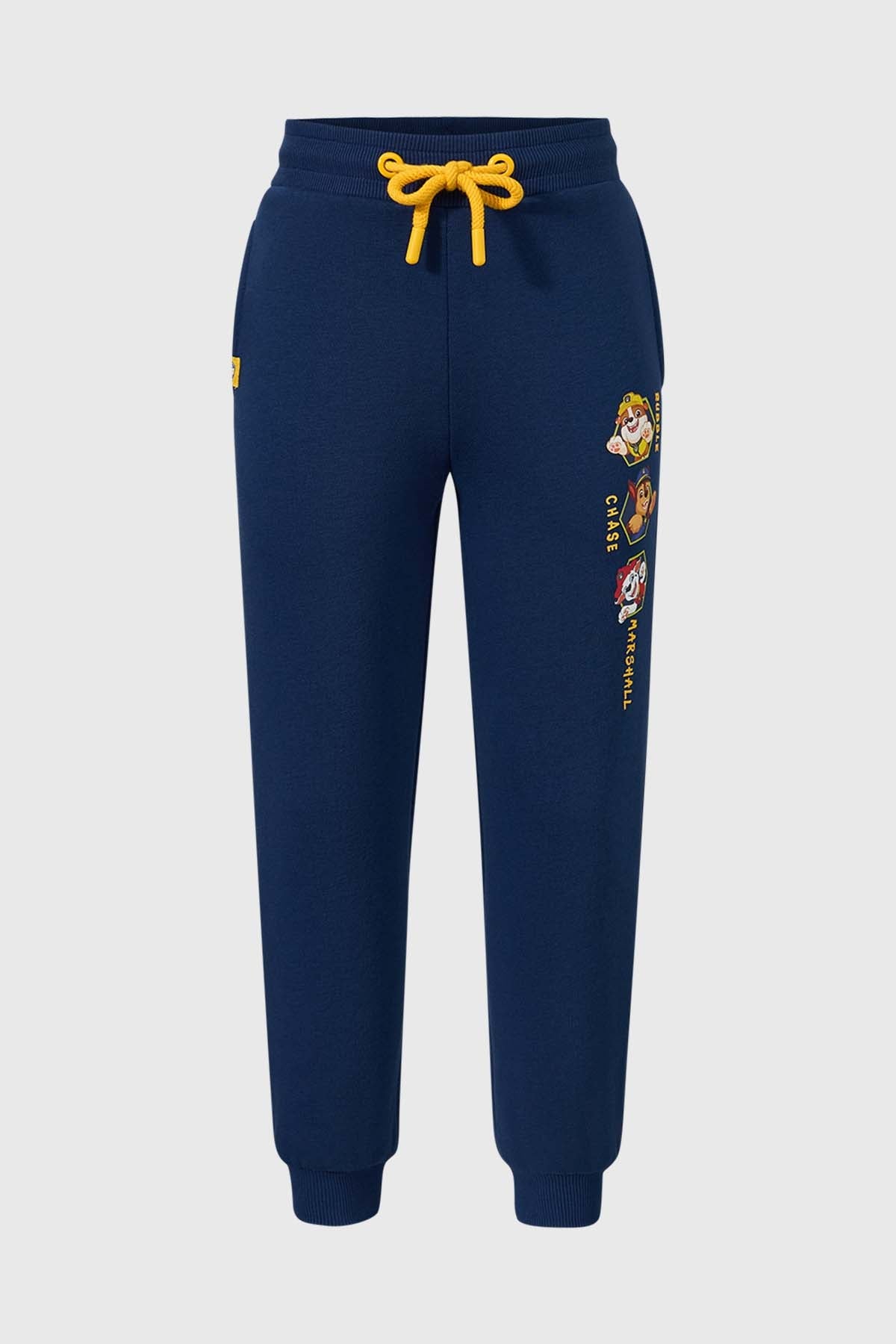 Pantalón buzo azul oscuro con estampado de los personajes de Paw Patrol, incluye a Chase, Marshall y Rubble, con detalles en amarillo y cordón ajustable.