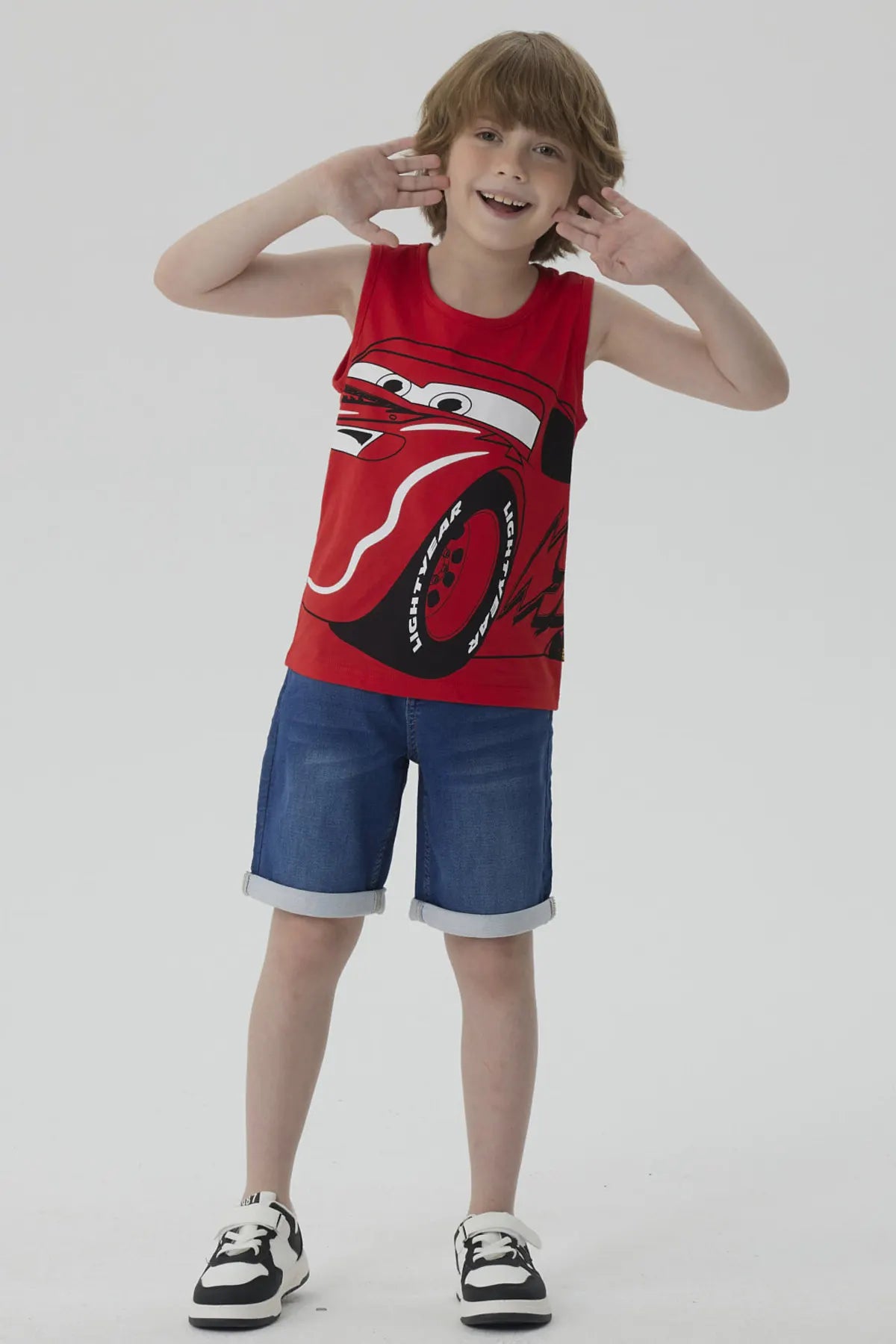 Polera roja de algodón con estampado de Rayo McQueen, el famoso auto de Cars, mostrando su icónica sonrisa y llantas, perfecta para fans de Pixar.