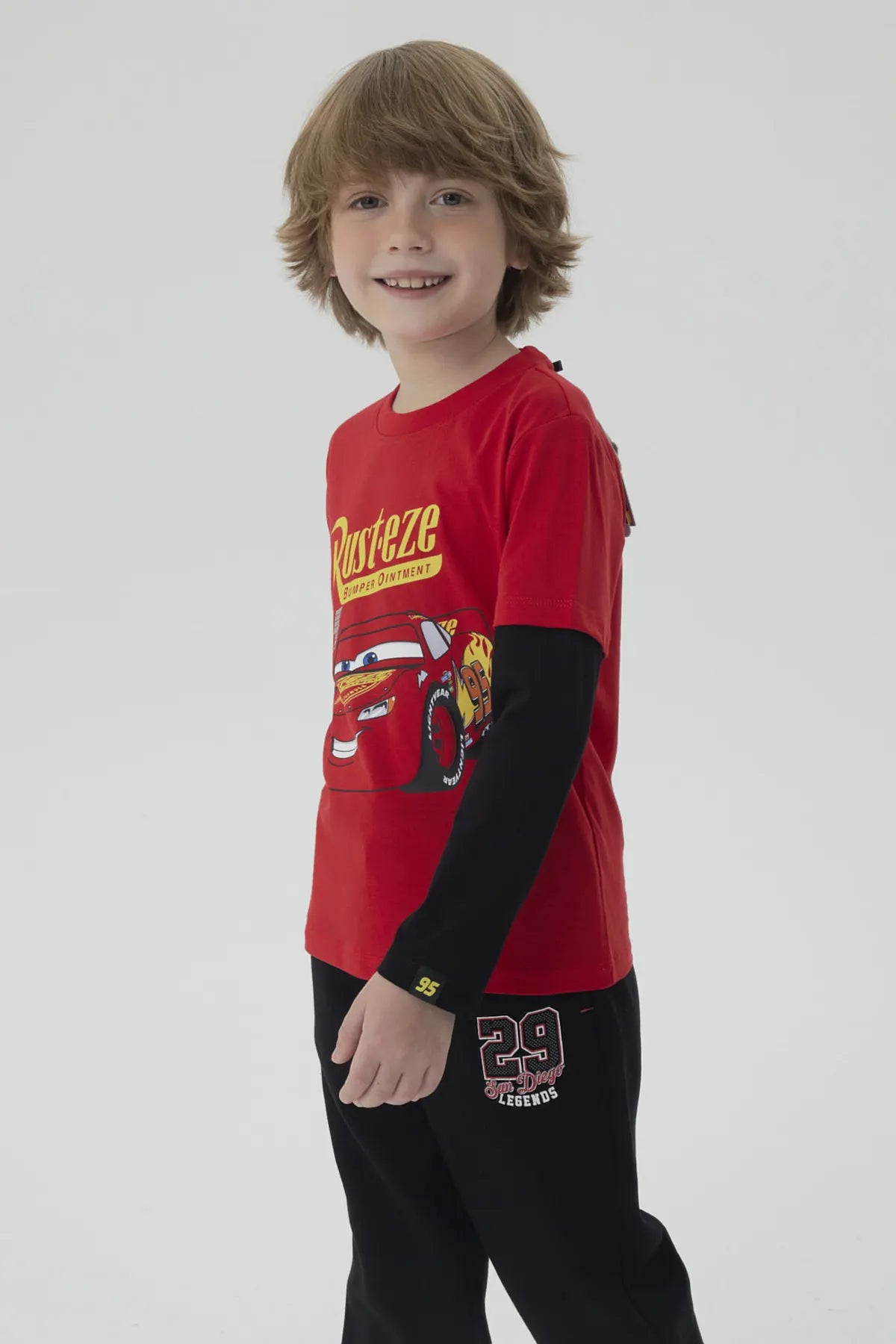 Polera roja de niño con estampado de Rayo McQueen de Cars, presenta el logo 'Rust-eze' y el número 95, ideal para los pequeños fanáticos de Pixar.